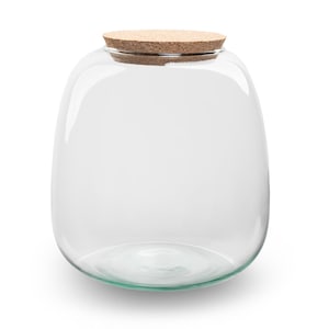 Pode incluir: Um frasco de vidro transparente com formato arredondado e tampa de cortiça natural. O frasco está vazio, permitindo que o conteúdo seja visível. Adequado para armazenamento ou exibição.