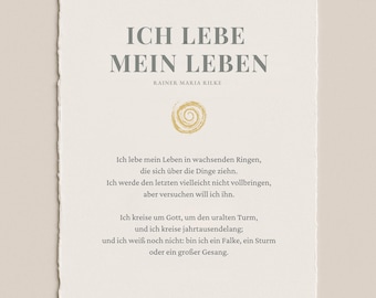 May include: A textured, off-white paper print featuring the German phrase "ICH LEBE MEIN LEBEN" in gray text. Below the title is the author's name, Rainer Maria Rilke. The print includes a gold spiral design and a poem in German.