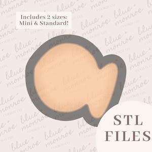 May include: A dark gray cookie cutter in the shape of a goldfish with a light peach-colored center. The image includes text that reads Includes 2 sizes: Mini & Standard! and STL FILES. The design features a rounded body and a small tail fin.
