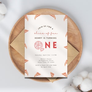 May include: A birthday invitation with a pizza theme. The invitation features the text "Join us for a slice of fun, Henry is turning ONE." The design includes pizza slice illustrations and a pizza graphic. The invitation is on a wooden plate with a brown envelope.