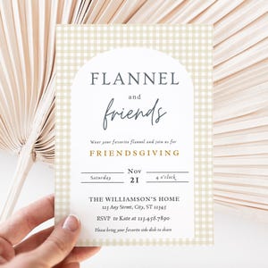 May include: A beige and white gingham patterned invitation card with a white arch and the text "FLANNEL and friends" in black and blue. The text "FRIENDSGIVING" is in gold. The invitation is for a Friendsgiving party on Saturday, November 21st at 4 o'clock at The Williamson's Home, 123 Any Street, City, ST 12345. The RSVP information is to Kate at 123.456.7890. The invitation requests guests to bring their favorite side dish to share.