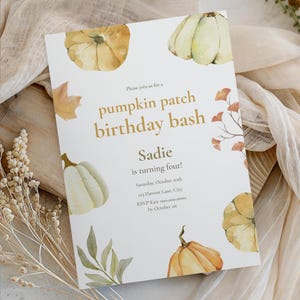 May include: A white invitation card with watercolor pumpkins and fall foliage. The text reads "pumpkin patch birthday bash" and announces Sadie's fourth birthday. Includes date, time, and RSVP information.