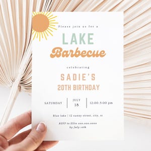 May include: A white invitation card with a sun graphic in the top left corner. The text reads "Please join us for a LAKE Barbecue celebrating SADIE'S 20TH BIRTHDAY. SATURDAY JULY 18 12:00-5:00 pm Blue lake | 12 sunny street, city, st RSVP to Ellie 000.000.0000 by July 10th"