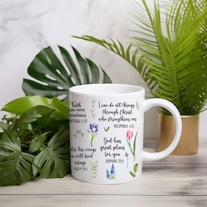 May include: White ceramic mug with inspirational quotes and floral illustrations. The quotes include "Faith can move mountains", "I can do all things through Christ who strengthens me", and "God has great plans for you".