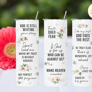 May include: Three white sublimation tumblers with floral designs and inspirational quotes. The quotes are "God is still writing your story", "Faith over fear", and "I do my best, God does the rest".
