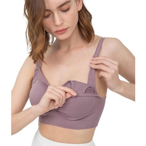 May include: A mauve-colored nursing bra with a built-in pocket for nursing pads. The bra has adjustable straps and a seamless design.