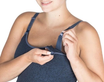 May include: A navy blue maternity nursing tank top with adjustable straps and a clip-down nursing panel. The tank top is made of a soft, textured fabric and is designed to accommodate a growing belly.