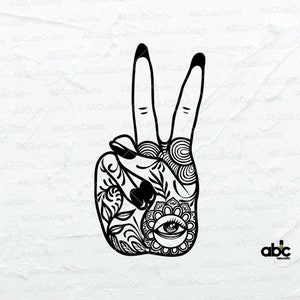 May include: Black and white line art illustration of a hand making the peace sign. The hand is decorated with intricate floral and mandala designs, including an eye in the centre of the palm.