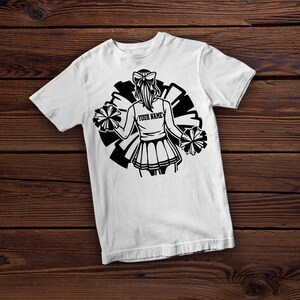 May include: White t-shirt with a black and white graphic of a cheerleader holding pom-poms. The graphic includes the text "YOUR NAME".