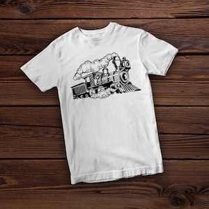 May include: White t-shirt with a black and white illustration of a vintage steam train with smoke coming from the chimney.