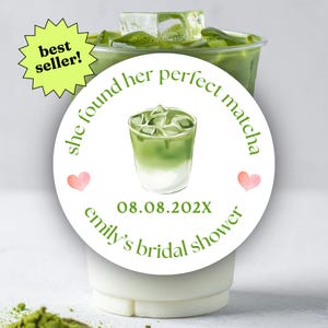 May include: A clear plastic cup filled with matcha tea and ice cubes, with a white sticker that says "she found her perfect matcha" and "emily's bridal shower". A green starburst sticker says "best seller!"