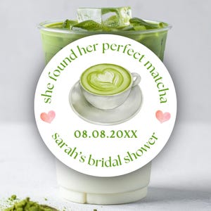 May include: A clear plastic cup filled with green matcha tea and ice cubes. A white circular sticker with the text "she found her perfect matcha" surrounds a watercolor image of a matcha latte. The sticker also includes the text "sarah's bridal shower" and the date 08.08.20XX.