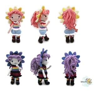 May include: Six crocheted dolls with rainbow-colored clothing and flower-shaped hair. Three dolls have pink hair and yellow flowers, and three dolls have purple hair and blue flowers.