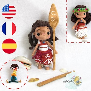 May include: A crocheted doll of Moana from the Disney movie Moana, holding a wooden paddle. The doll is wearing a red and white dress and a blue necklace. The doll is standing on a white surface with seashells scattered around it.