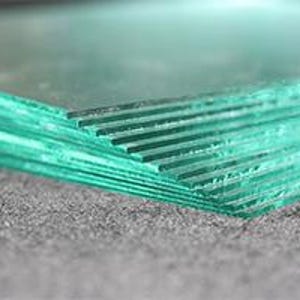 May include: A stack of clear glass sheets, likely for crafting or other projects.