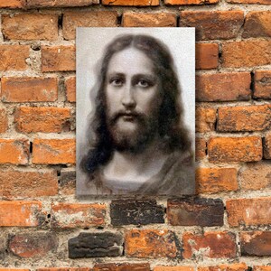 May include: A black and white portrait of a man with long hair and a beard. The man is looking directly at the viewer. The image is in a simple frame.