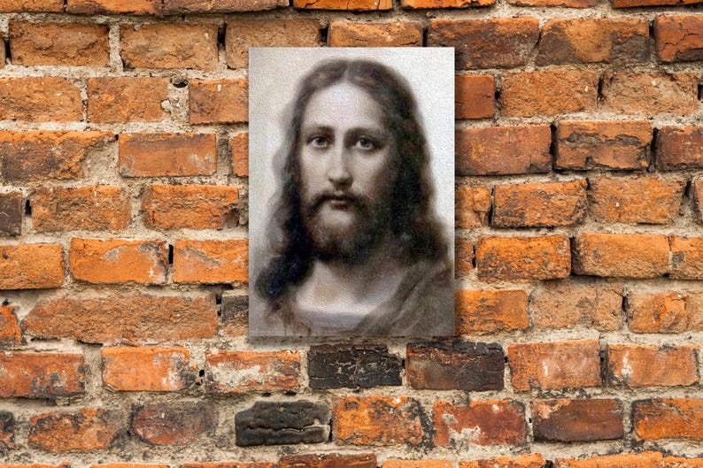 May include: A black and white portrait of a man with long hair and a beard. The man is looking directly at the viewer. The image is in a simple frame.
