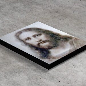 May include: A black and white portrait of Jesus Christ with a soft, ethereal look. The image is printed on a canvas with a black frame.
