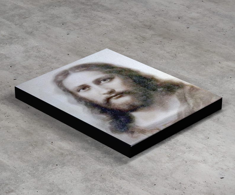 May include: A black and white portrait of Jesus Christ with a soft, ethereal look. The image is printed on a canvas with a black frame.
