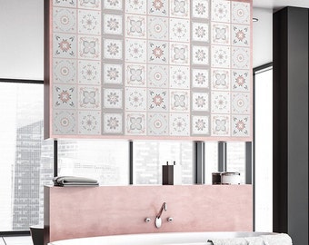 May include: A bathroom with a pink bathtub and a wall covered in white and gray patterned tiles. The tiles have a pink and gray floral design.