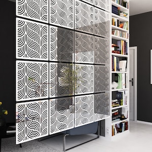 May include: White room divider made of interlocking panels with a geometric pattern. The panels are made of a lightweight material and can be easily assembled and disassembled.