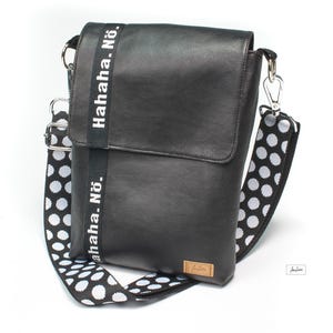 May include: Black leather crossbody bag with a white polka dot strap. The strap has the text "Hahaha. No." printed on it.