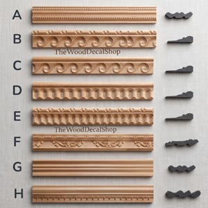 May include: A collection of eight wooden molding strips labeled A through H, each featuring distinct carved patterns and a corresponding black cross-section profile on the right. The text TheWoodDecalShop appears twice on the light background.