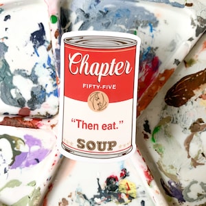 May include: A red and white soup can sticker with the text "Chapter Fifty-Five" and "Then eat."  The can also has the text "Soup" with stars on either side.