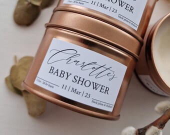 May include: Two copper candle tins with white labels. The labels have the text "Charlotte's Baby Shower" with the date "11 | Mar | 23" and the scent "black plum & rhubarb".