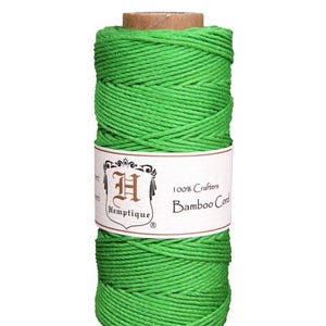 May include: A spool of bright green 100% crafters bamboo cord. The label reads "Hemptique 100% Crafters Bamboo Cord".