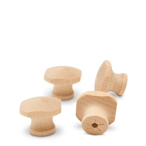 May include: Four unfinished wooden cabinet knobs. The knobs have a mushroom-like shape with a flat top and a rounded base. The wood is a light, natural color.