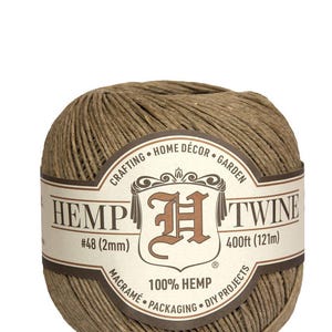 May include: A ball of natural brown hemp twine with a label that reads "Hemp Twine" and "100% Hemp". The label also includes the size #48 (2mm) and the length 400ft (121m).