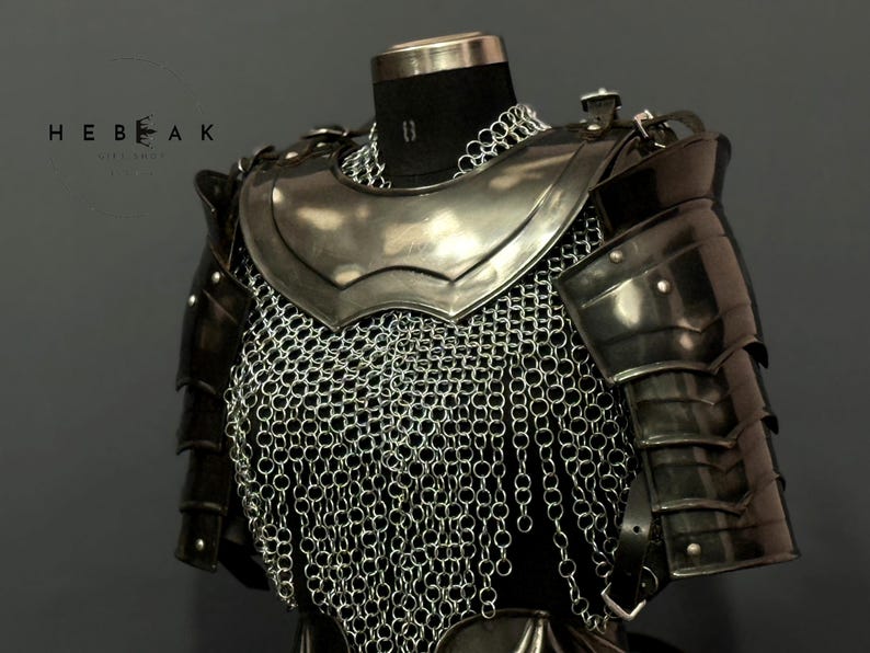 May include: A medieval-style chest armor set, featuring a polished metal breastplate, shoulder guards, and chainmail. The armor is displayed on a black mannequin, with the brand name "HEBEAK" visible in the upper left corner.