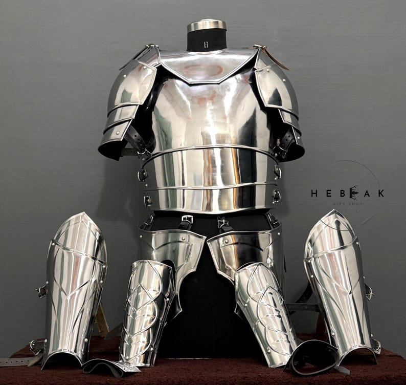 May include: A full suit of silver armor with a breastplate, pauldrons, and greaves. The armor is displayed on a mannequin against a gray background. The text "HEBEAK" is visible in the image.