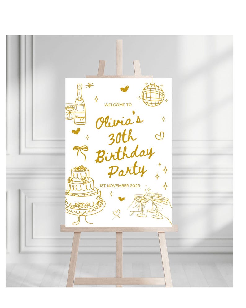 May include: A gold-colored sign on an easel, announcing "Olivia's 30th Birthday Party" with illustrations of champagne, a cake, and disco ball. The date "1st November 2025" is also displayed. The sign is on a wooden easel.