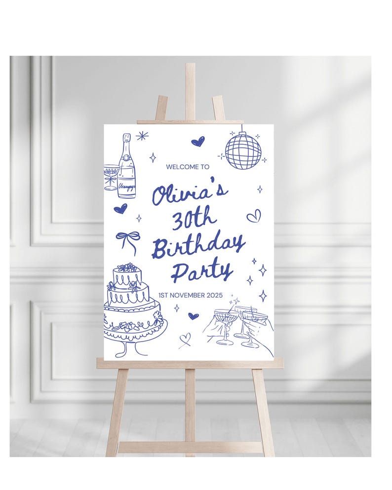 May include: A white sign on a wooden easel with blue line art. The sign reads "Welcome to Olivia's 30th Birthday Party" with illustrations of a cake, champagne, and disco ball. The date "1st November 2025" is also included.