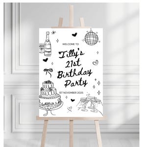 May include: A black and white sign on an easel, welcoming guests to "Tilly's 21st Birthday Party." The sign features illustrations of a champagne bottle, disco ball, cake, and champagne flutes. The date "1st November 2025" is also displayed.