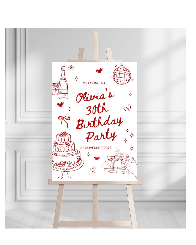 May include: A white sign on an easel with red illustrations and text. The sign reads "Welcome to Olivia's 30th Birthday Party" with a cake, champagne bottle, disco ball, and glasses. The date "1st November 2025" is also included.