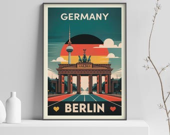 May include: A framed travel poster depicting the Brandenburg Gate in Berlin, Germany. The poster has a retro design with the word "GERMANY" at the top and "BERLIN" at the bottom. The sky is teal, with a red and orange sun.