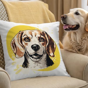 Op de afbeelding: Wit vierkant sierkussen met een illustratie van een beagle hond. De kop van de hond staat centraal op een gele cirkel met een aquareleffect. De beagle heeft bruine en witte vacht en lacht. Op de achtergrond is een golden retriever te zien.