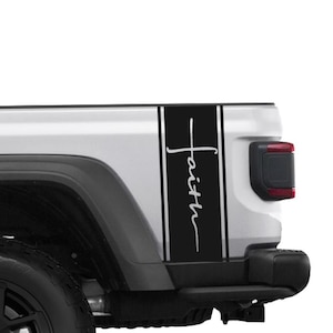 May include: A black and white decal applied to the side of a white vehicle. The decal features the word "Faith" in a cursive font, set against a black background with white vertical stripes.