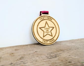 Personalised kids sized wooden medals with or without ribbon. Custom wooden medals for children that can include any wording and logo.
