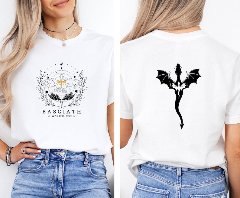 May include: White t-shirt featuring a black and gold graphic on the front with the text "BASGIATH WAR COLLEGE". The back of the shirt displays a black dragon silhouette. The shirt is made of a soft material.