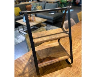 May include: A two-tiered wooden shelf with a black metal frame. The shelf has a simple design and is perfect for displaying small items.