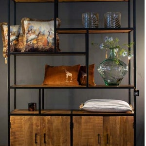 May include: A black metal and wood shelving unit with four doors. The shelves are filled with decorative items, including pillows, vases, and candles.