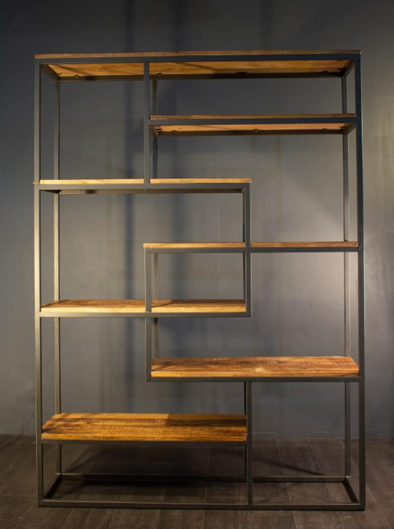 May include: A black metal bookshelf with multiple shelves made of reclaimed wood. The shelves are arranged in a geometric pattern.
