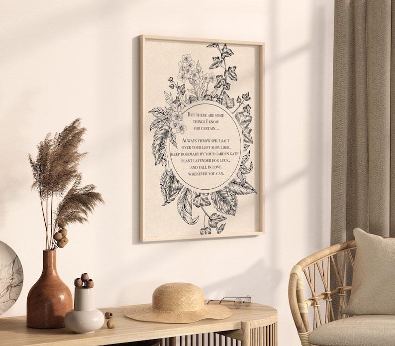 Vintage-inspired black and white botanical illustration featuring flowers and leaves framing a circular quote. The text inside reads: "But there are some things I know for certain… Always throw spilt salt over your left shoulder, keep rosemary by your garden gate, plant lavender for luck, and fall in love whenever you can." The artwork has an old-world, mystical feel, reminiscent of traditional herbal folklore or a page from an apothecary book.