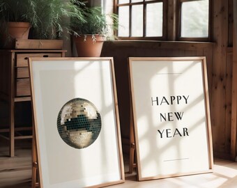 May include: Two framed prints, one with a gold disco ball and the other with the text "HAPPY NEW YEAR" in black.