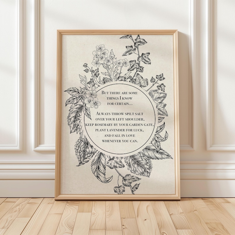 Vintage-inspired black and white botanical illustration featuring flowers and leaves framing a circular quote. The text inside reads: "But there are some things I know for certain… Always throw spilt salt over your left shoulder, keep rosemary by your garden gate, plant lavender for luck, and fall in love whenever you can." The artwork has an old-world, mystical feel, reminiscent of traditional herbal folklore or a page from an apothecary book.