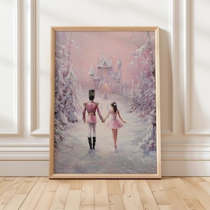 May include: A framed painting depicts a soldier and a ballerina walking hand-in-hand through a snowy landscape. The soldier wears a pink uniform and black boots, while the ballerina is in a pink tutu. A castle is visible in the background, and the scene is painted in soft pink and white hues.